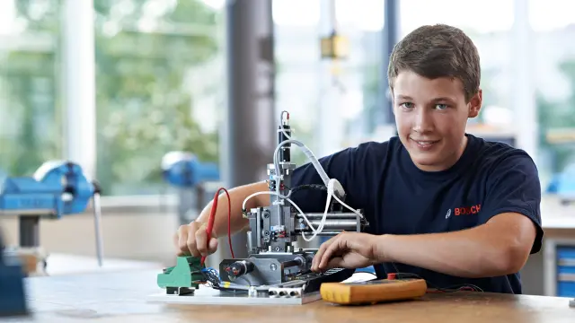young boy working with technical hardware 
