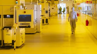 Zwei Ingenieure stehen beratend an einem Monitor mit KI-Daten.